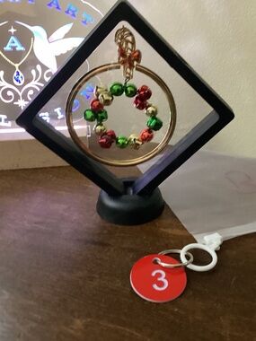 Hand crafted Christmas jewelry art red gold green floating jingle bells stand